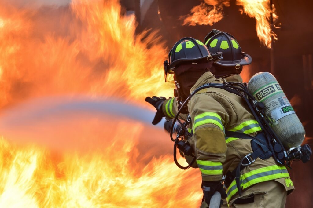 Two firemen putting out a wildfire