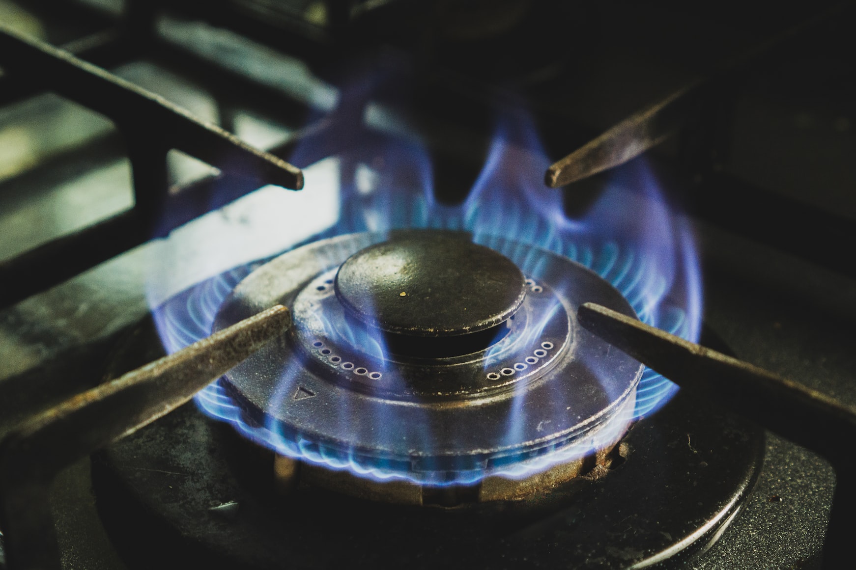 Gas stove turned on with flame ignited.