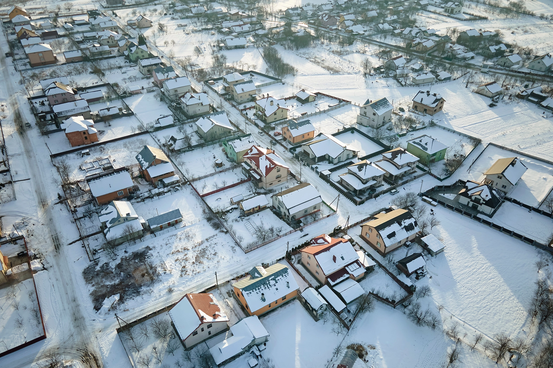 A bird's eye view of a community in the winter with snow.